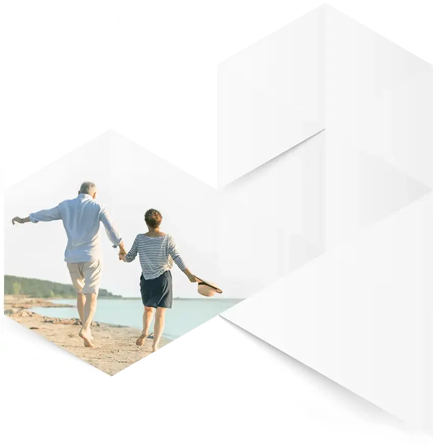 An elderly couple enjoying a peaceful day on the beach.