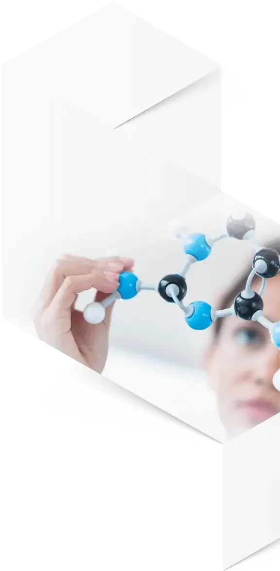 Woman holding up a plastic model of a molecule